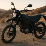 Best electric dirt bike under $2000 parked on a rugged dirt trail at sunset