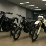 How much does a Sur Ron cost - Ultra Bee, Light Bee X and Storm Bee electric bikes showcased in a modern indoor showroom with LED lighting