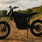 cheap electric dirt bike for beginners standing on a sunset dirt trail with rugged tires and sleek frame design