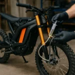 how to bleed brakes on electric dirt bike being serviced in a workshop with hydraulic brake fluid bleed process